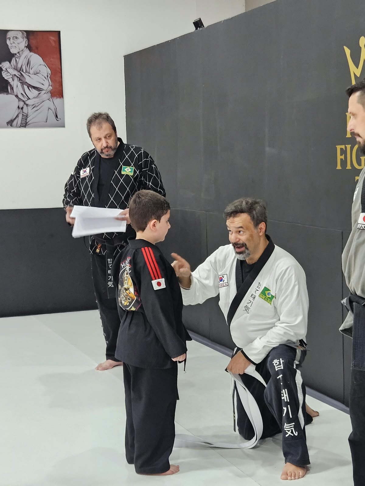 Instrutor de artes marciais orientando um jovem aluno